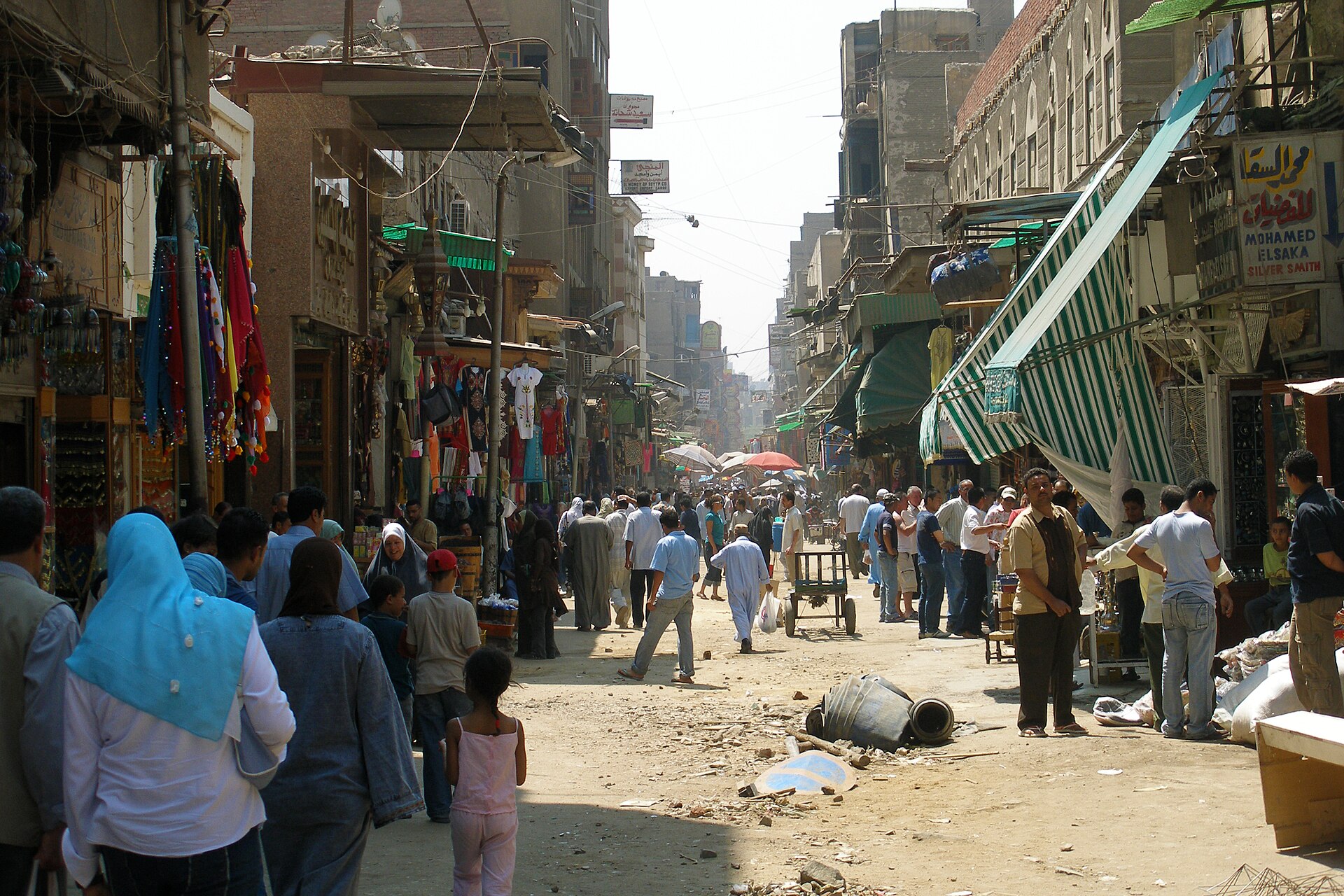 A busy shopping street in Cairo, Egypt, lined with shops and shoppers