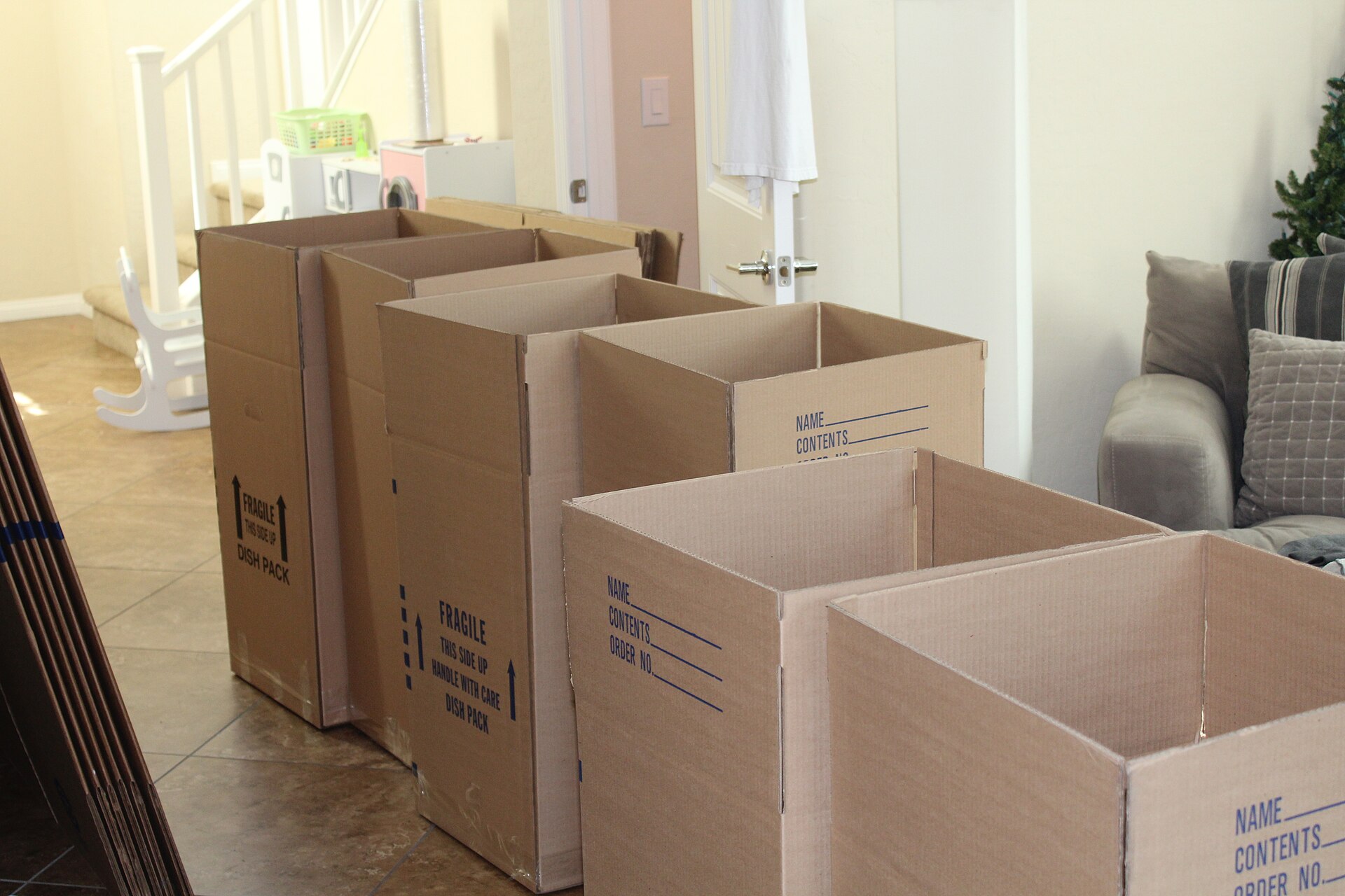 Assembled cardboard moving boxes in a room being packed up