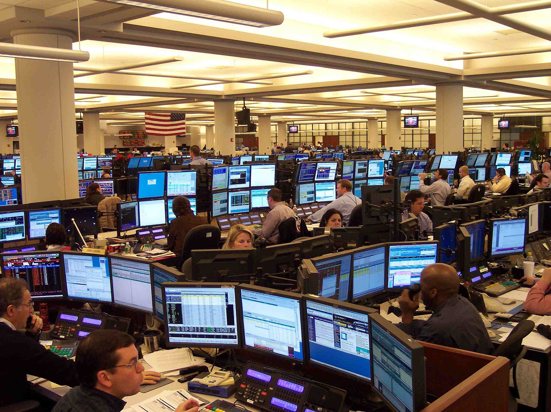 A data-dense trading floor lined with rows of analytics screens