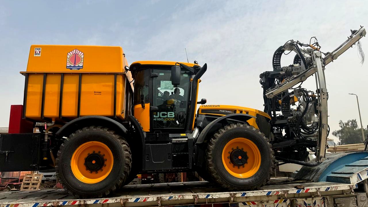 PNM Group's NREA parabolic-mirror cleaning rig mounted on a tractor, used for operation and maintenance at a concentrated solar power plant