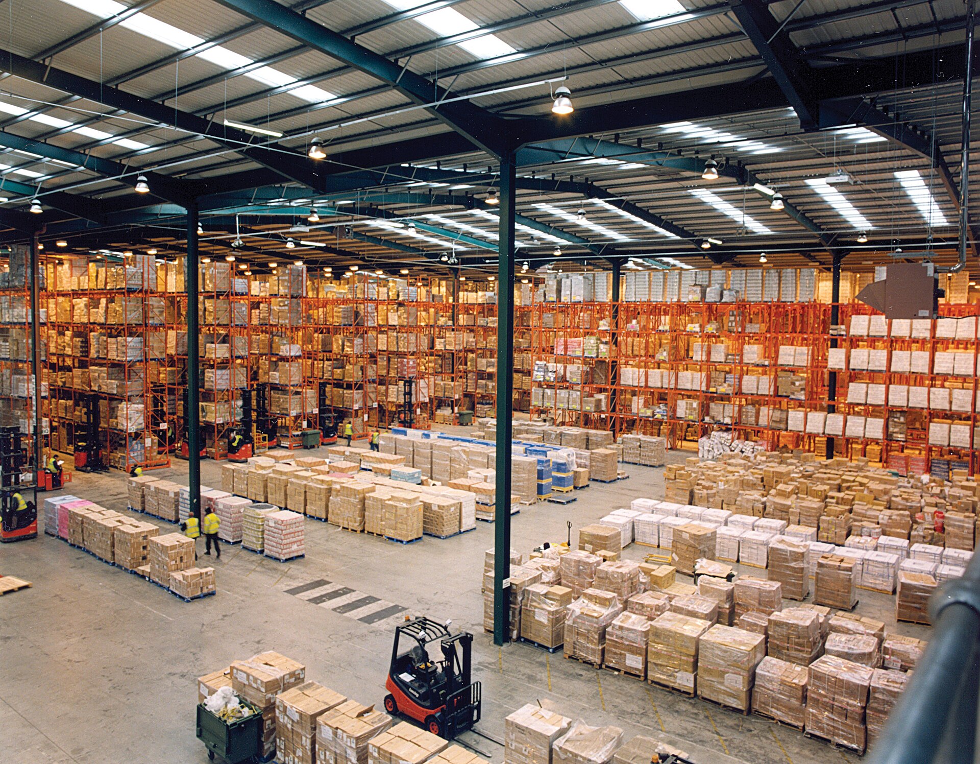 The interior of a modern warehouse with pallet racking full of goods